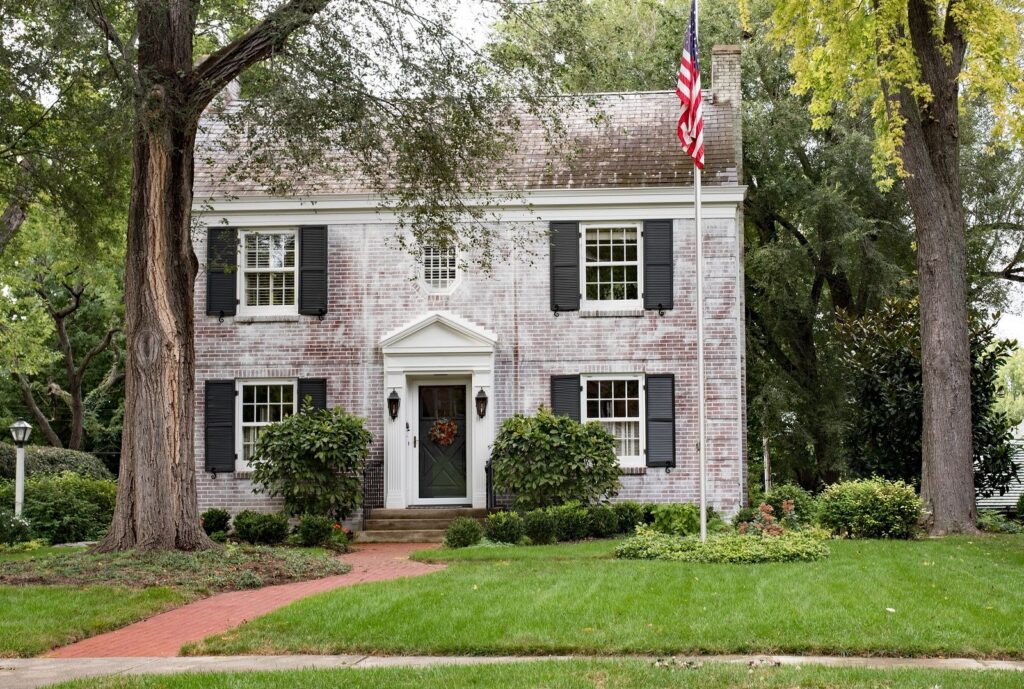 An antique colonial brick house representing the historic sanctuary of early American family homes.