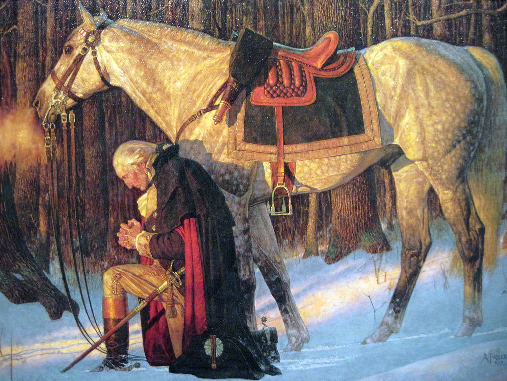 An historic painting depicting General George Washington kneeling in prayer in the snow at Valley Forge.
